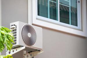 air conditioner compressor outdoor unit installed outside the house photo