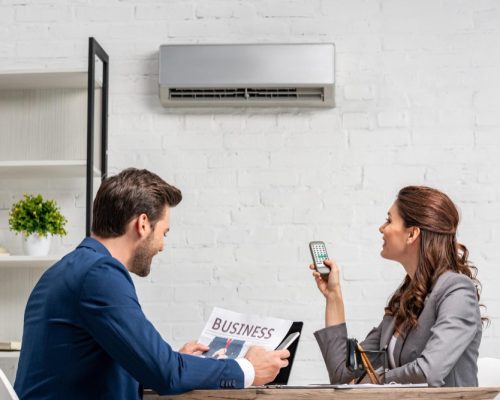 businessman reading business newspaper while sitting desk near pretty woman holding remote pz8901ejolp77yv6ymahy5cu2vtxs0fl79eilbycv4